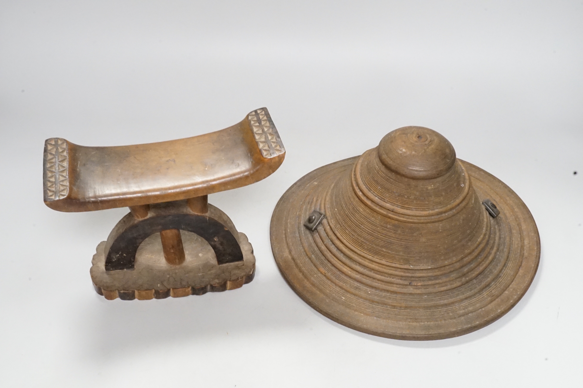 An Ashanti wood headrest and a small African wood shield